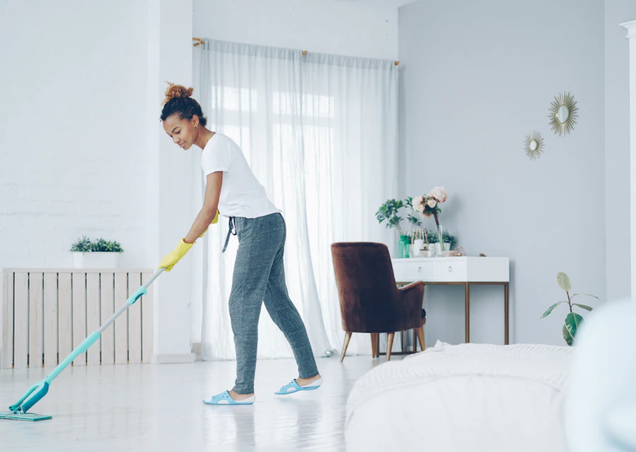 Cleaner mopping a bright living room floor